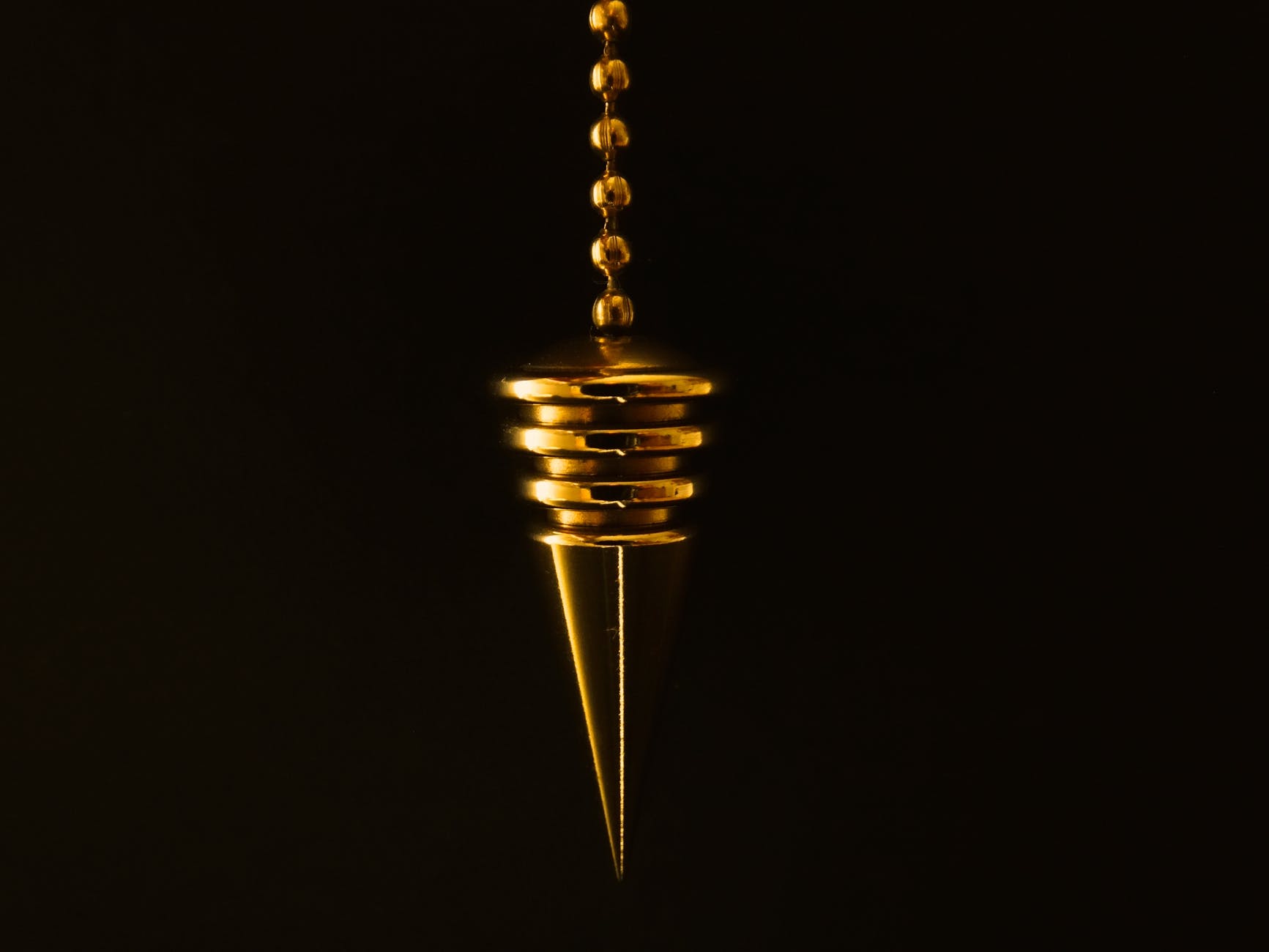 hanging gold colored pendant with necklace