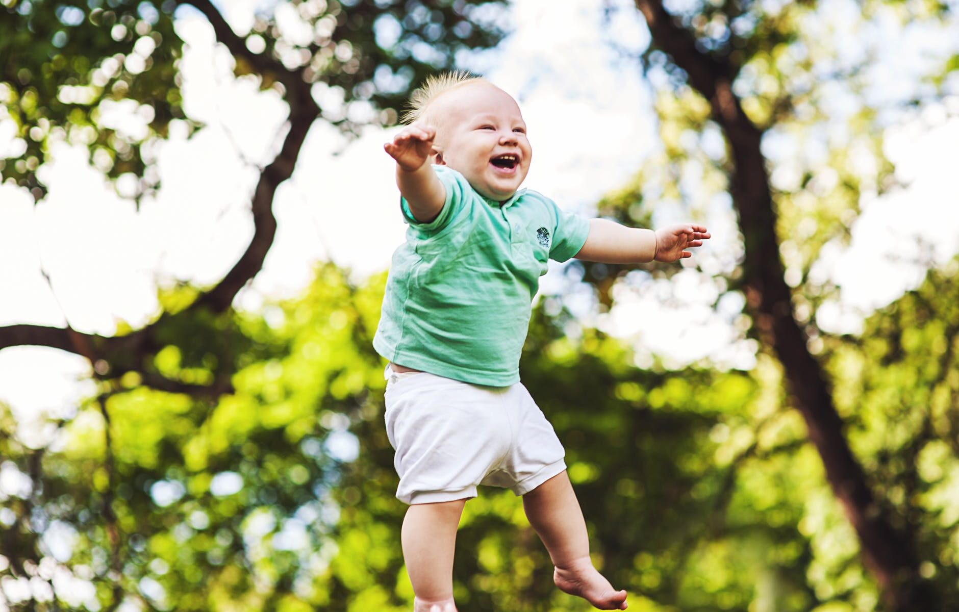 laughing baby floating on air