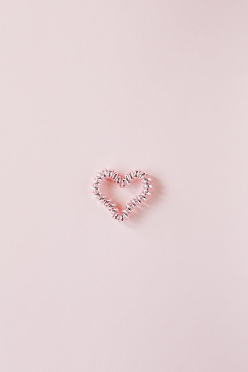decorative heart of elastic coil on pink background
