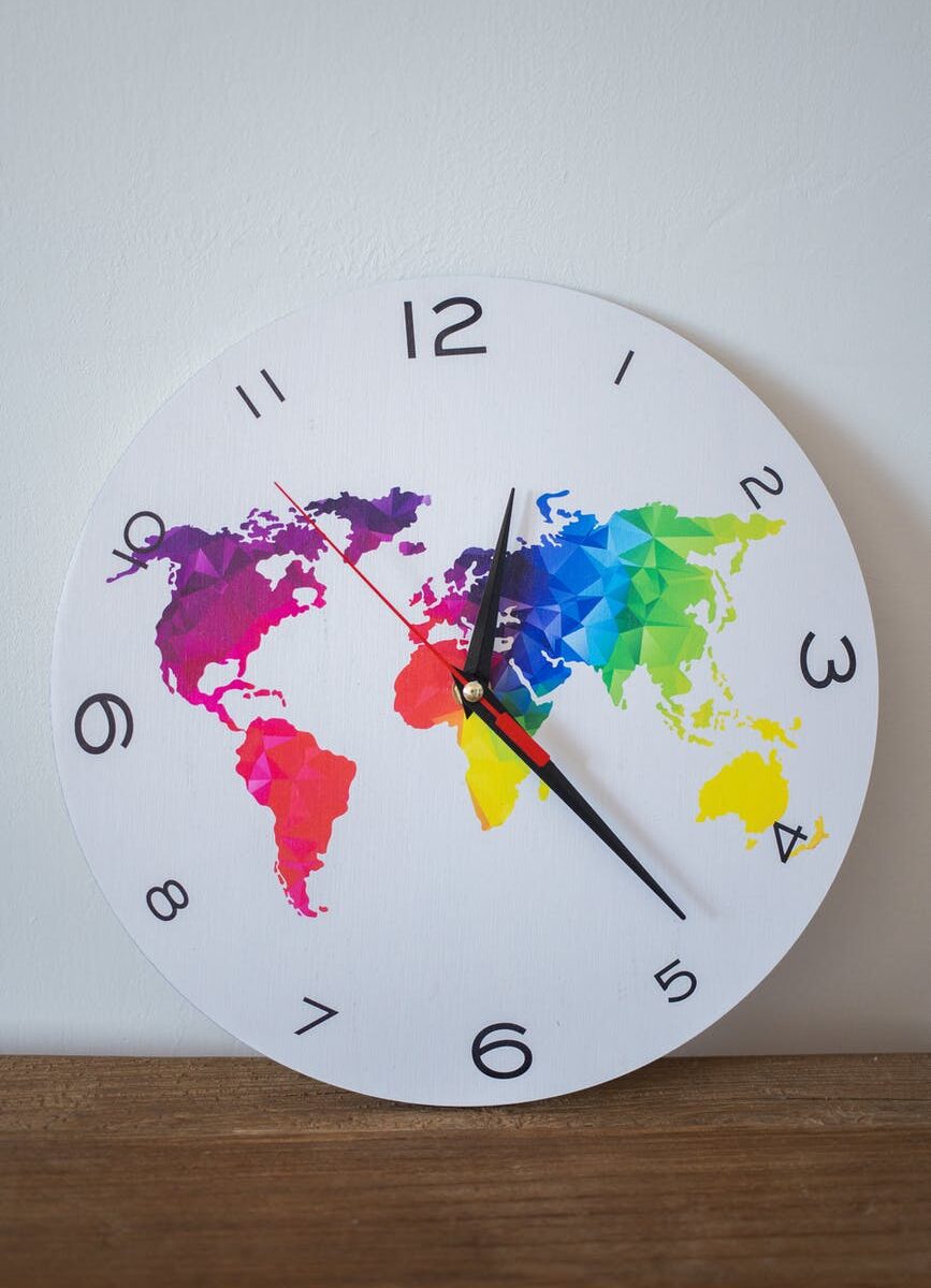 a wall clock with a colorful world map design