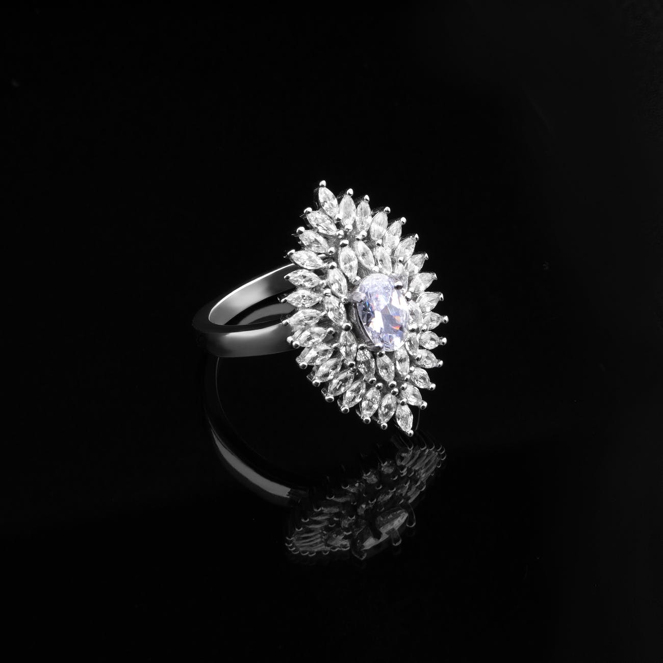grayscale photography of a ring with diamonds