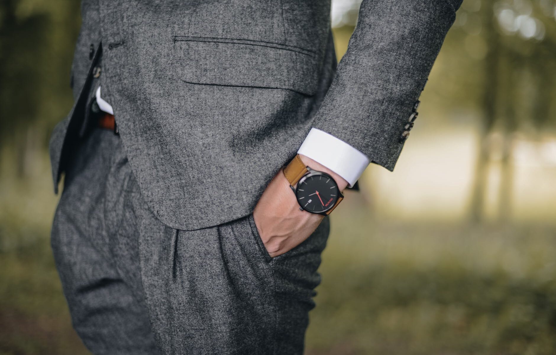 man wearing watch with hand on pocket