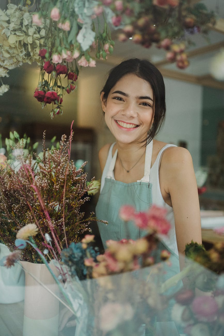 cheerful young florist in shop