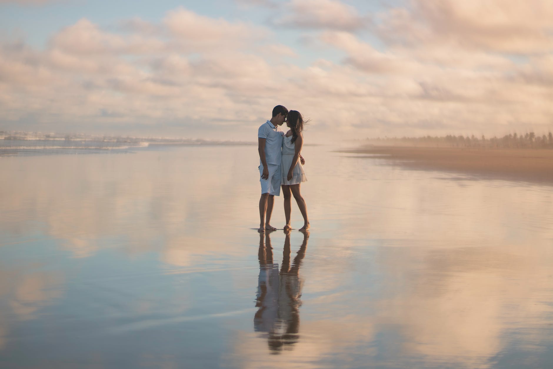 photo of couple standing on water