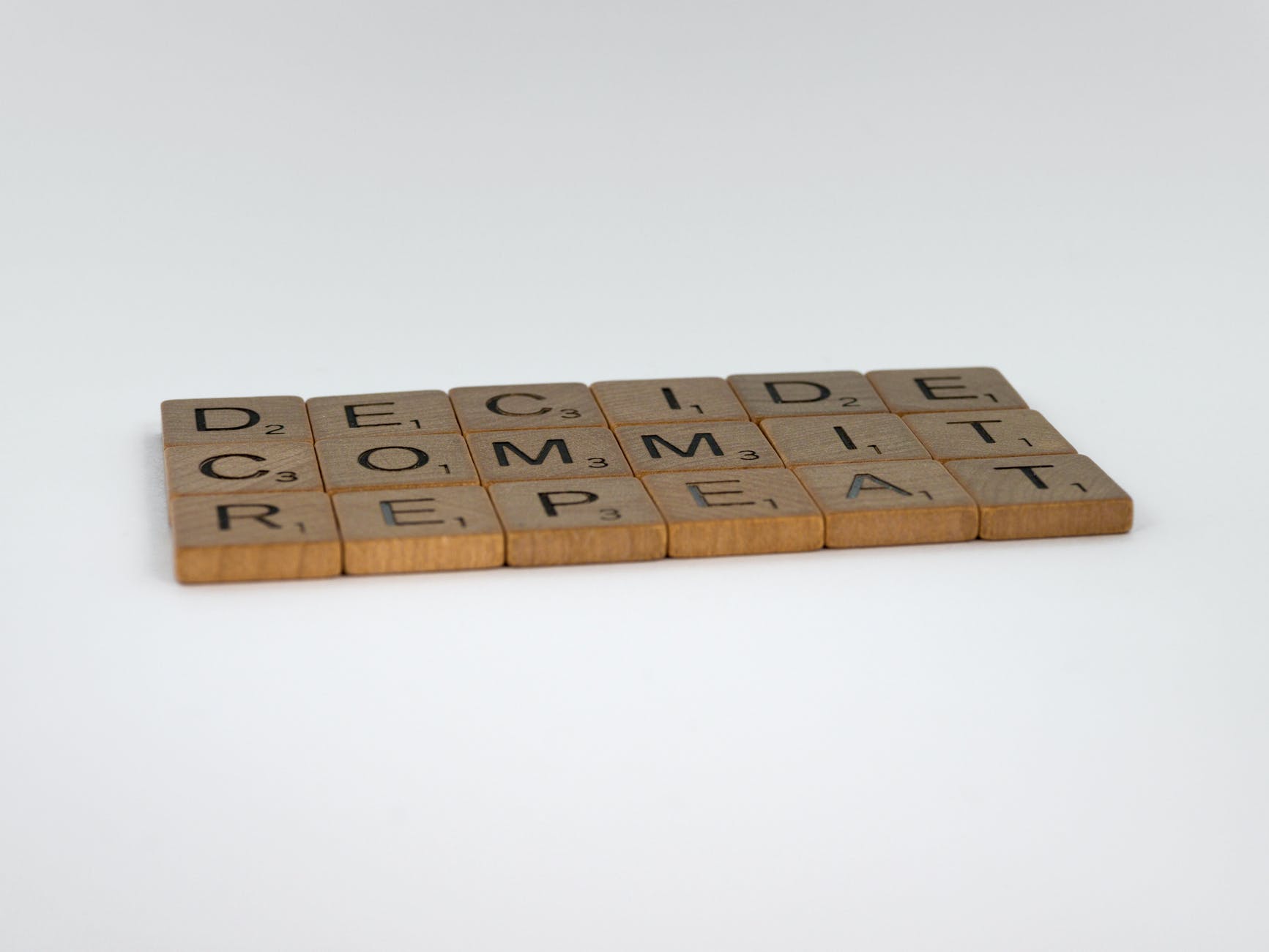 a scrabble tiles quote on a white background